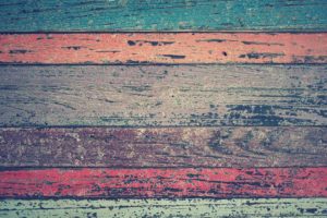 picture of wood panels in different colors (turquoise, orange, gray, brown, pink, green)