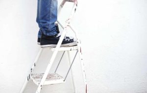 picture of person standing on stepstool